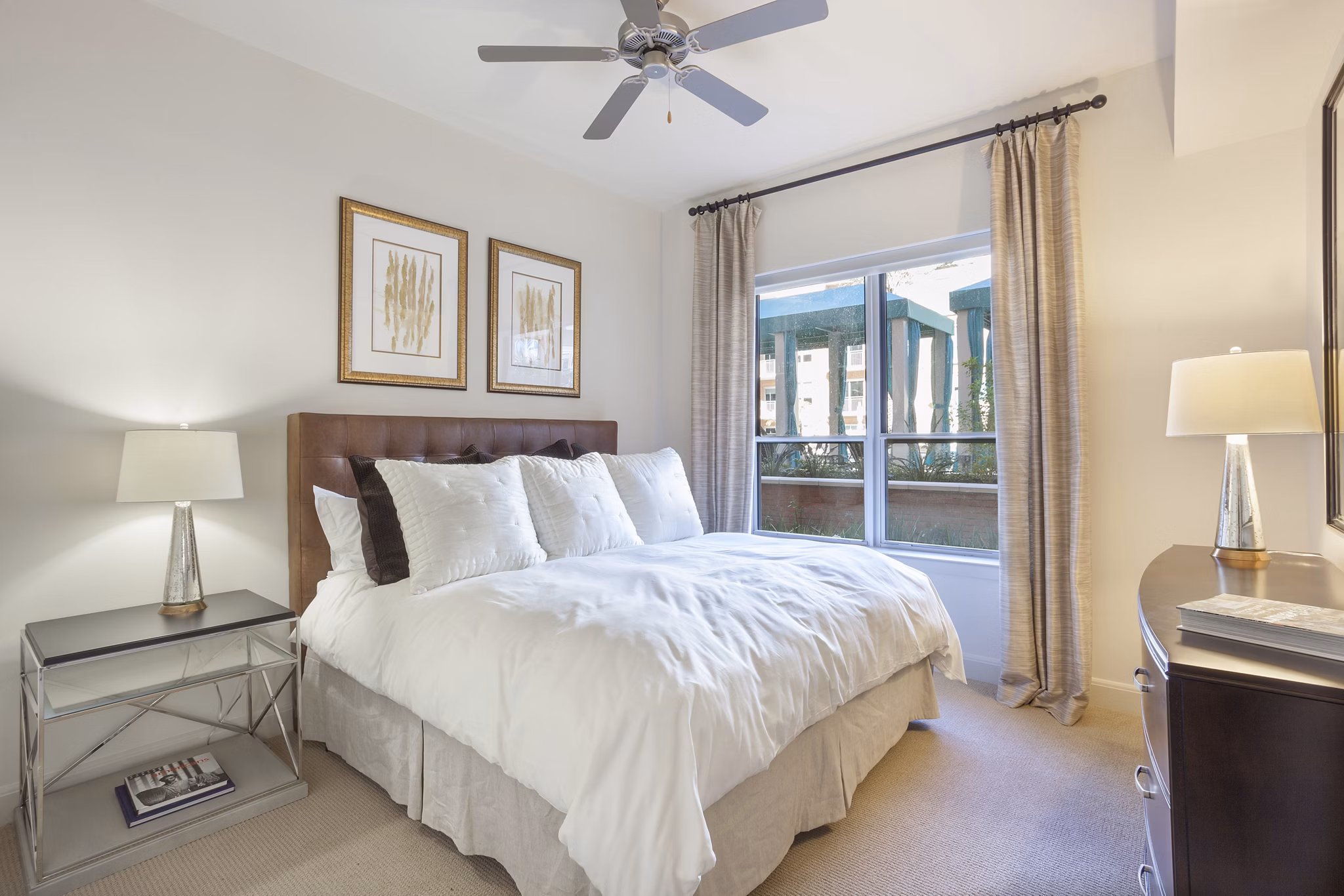 Spacious bedroom featuring modern design and large windows at One Lakes Edge apartments