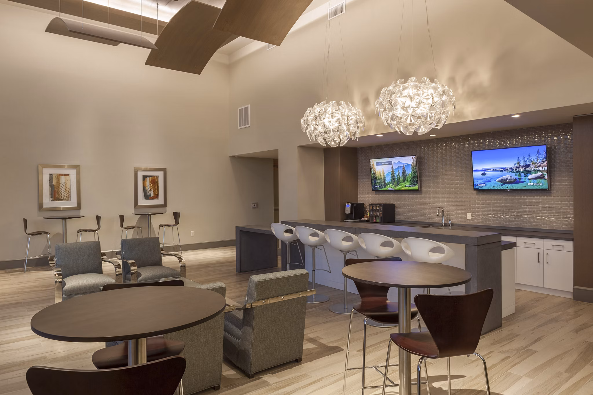Clubhouse with upscale furnishings and modern lighting at One Lakes Edge luxury apartments in a vibrant community