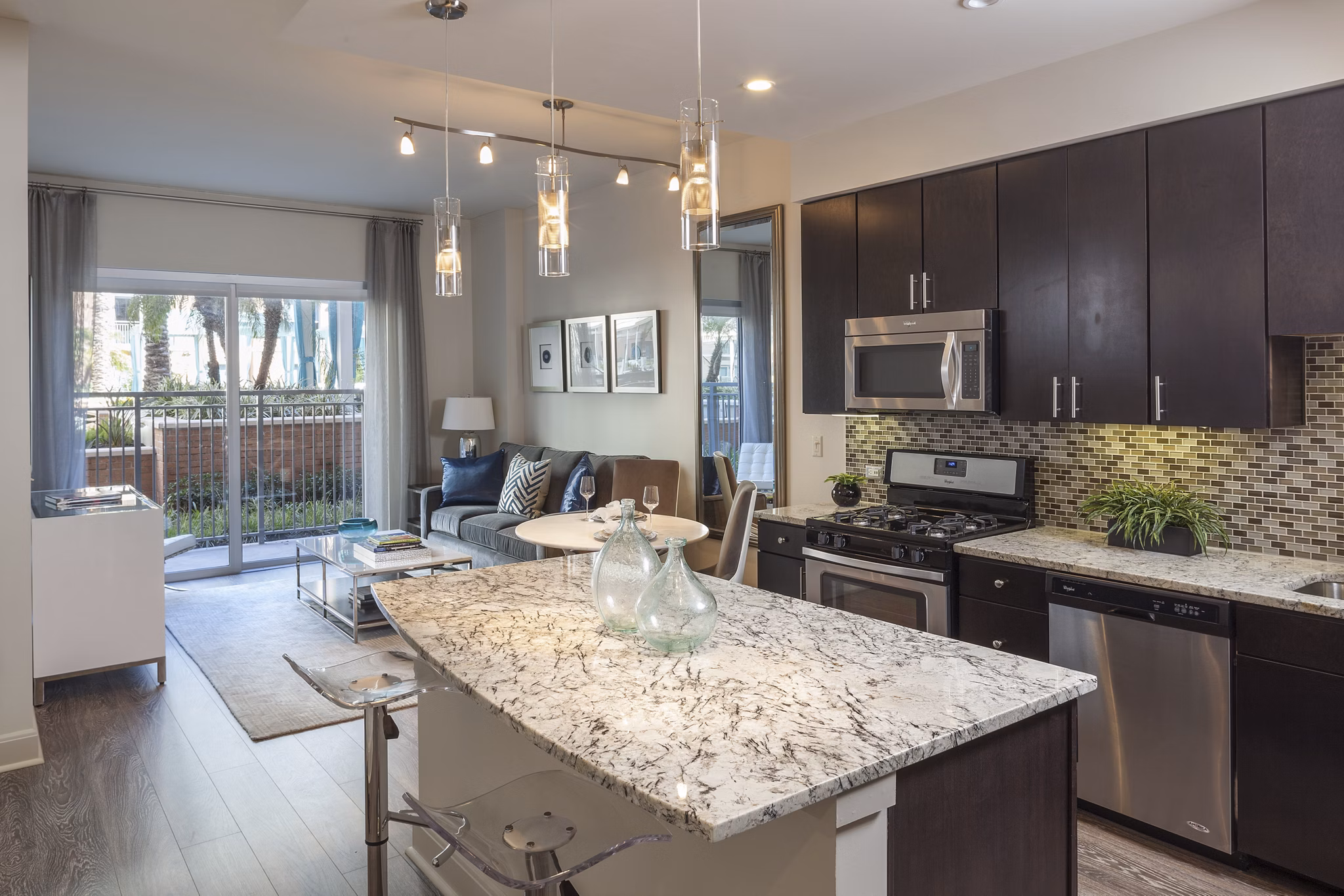 Kitchen with modern appliances and island counter at One Lakes Edge luxury apartments