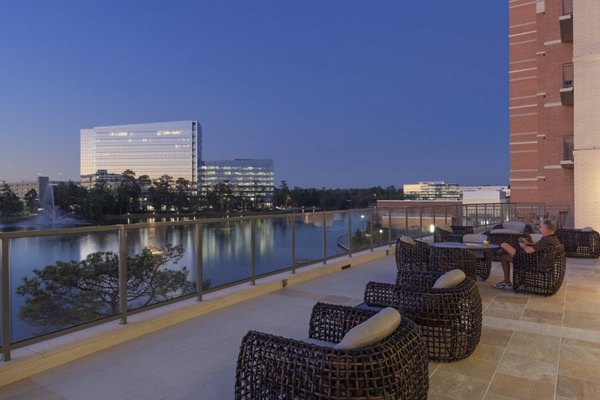Courtyard with modern seating and lush greenery at One Lakes Edge luxury apartments
