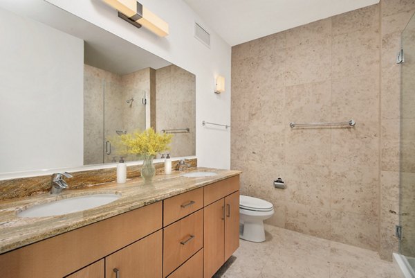 Contemporary bathroom with sleek fixtures and modern design at Aston Apartments in luxury setting