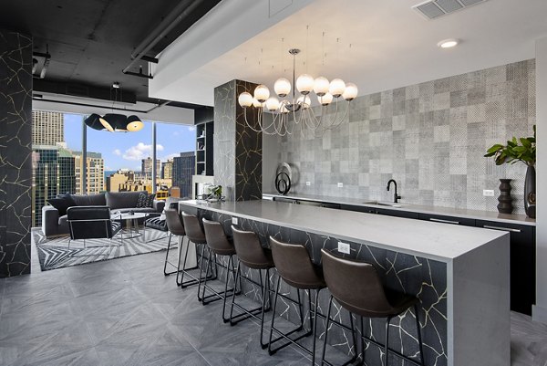 Clubhouse featuring modern design and cozy seating at Aston Apartments