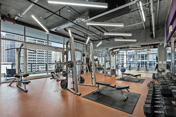 State-of-the-art fitness center with modern equipment at Aston Apartments, ensuring an exceptional workout experience for residents
