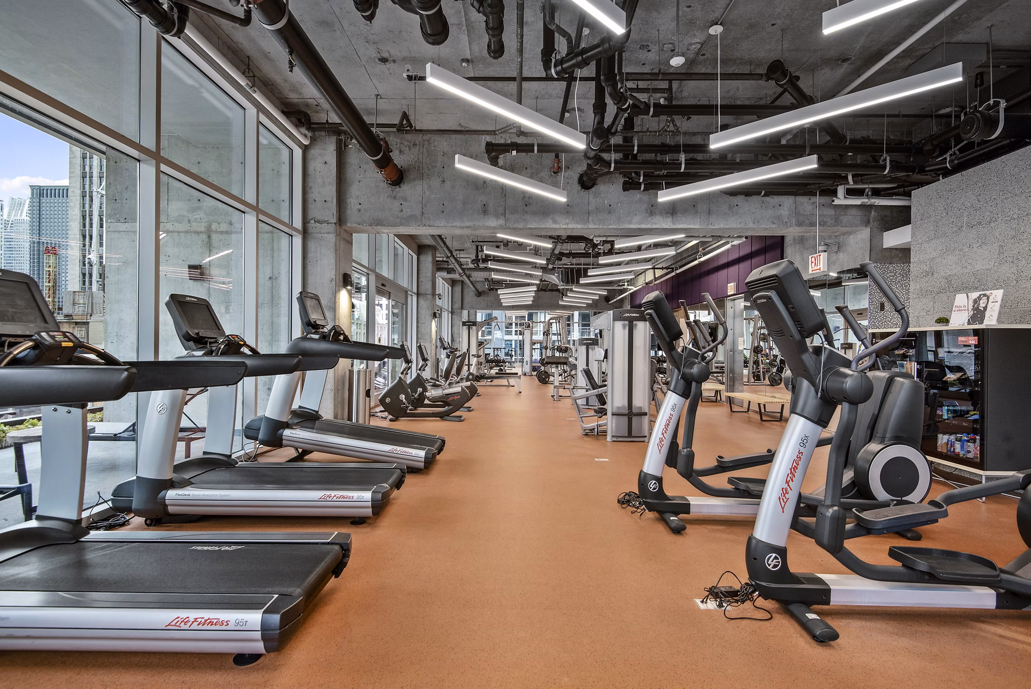 State-of-the-art fitness center at Aston Apartments offering modern equipment and spacious workout areas