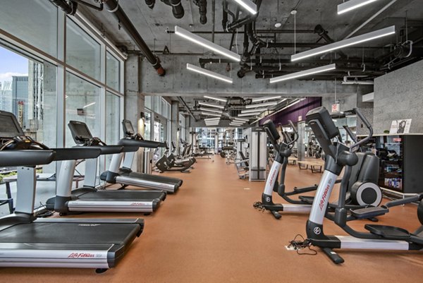 State-of-the-art fitness center at Aston Apartments offering modern equipment and spacious workout areas