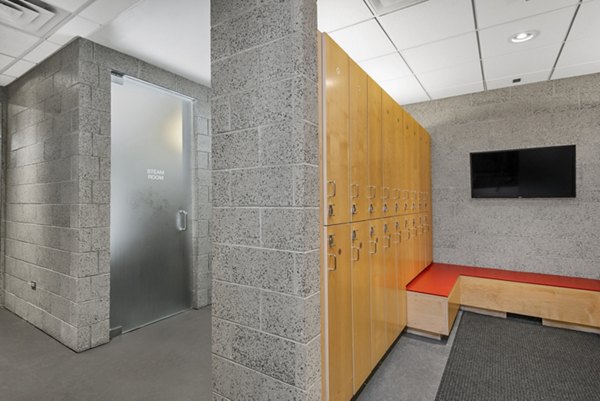 State-of-the-art fitness center at Aston Apartments with modern exercise equipment and bright natural lighting
