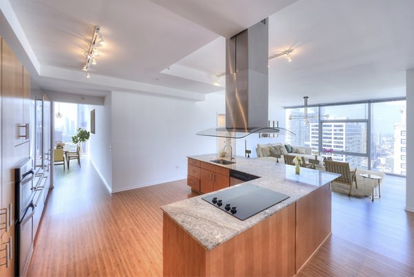 Modern kitchen with stainless steel appliances at Aston Apartments