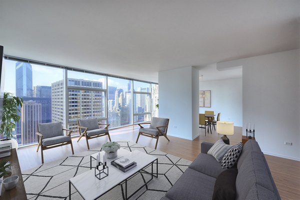 Modern living room with stylish decor in Aston Apartments, featuring comfortable seating and large windows for natural light