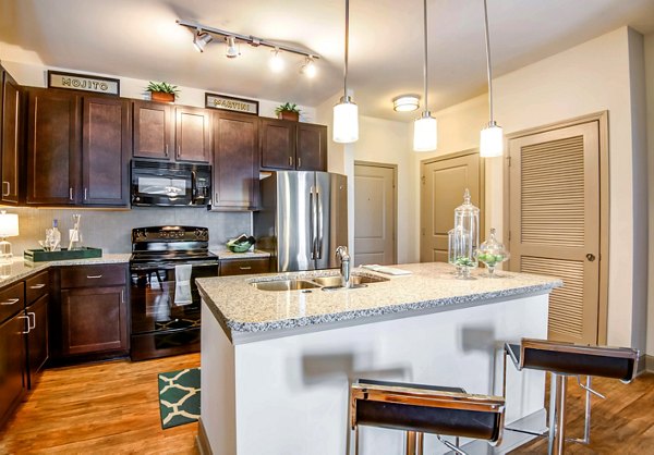 Modern kitchen with stainless steel appliances at Jones Grant Luxury Apartments