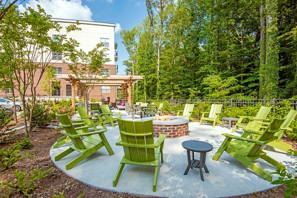 Cozy outdoor fire pit at Jones Grant Luxury Apartments, perfect for relaxing and socializing in a luxurious setting