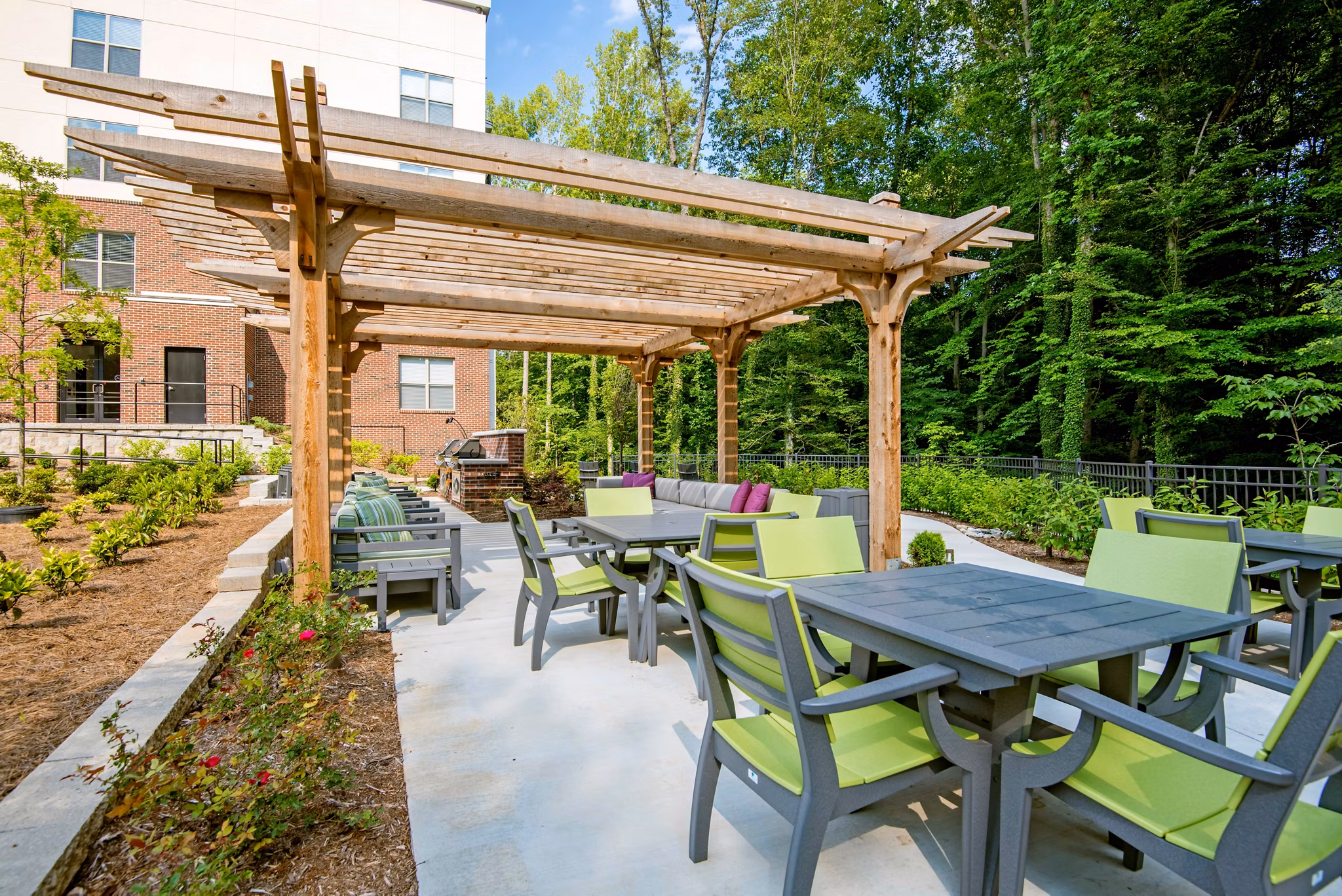 Outdoor grill area with modern seating at Jones Grant Luxury Apartments