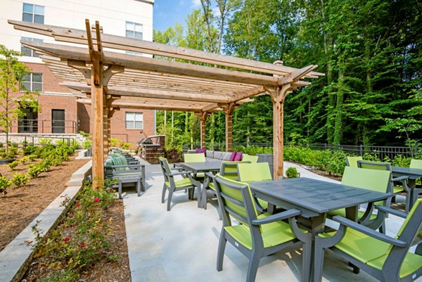 Outdoor grill area with modern seating at Jones Grant Luxury Apartments