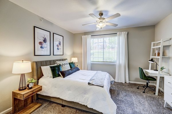 Cozy bedroom with queen-size bed and modern decor at Champions Apartments