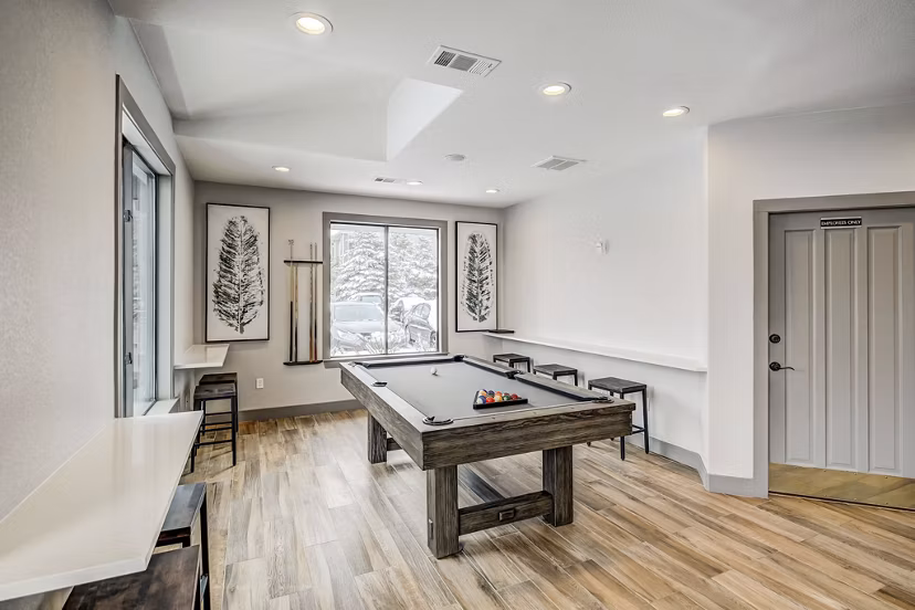 Modern clubhouse with stylish seating and large-screen TV at Champions Apartments Ideal for social gatherings and casual relaxation