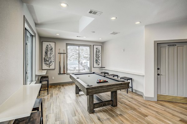 Modern clubhouse with stylish seating and large-screen TV at Champions Apartments Ideal for social gatherings and casual relaxation