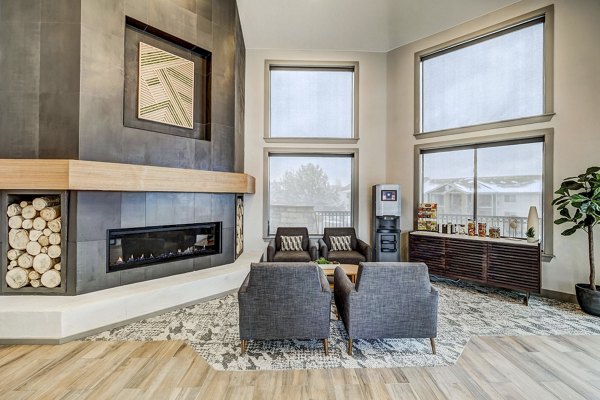 Stylish clubhouse with modern decor at Champions Apartments, featuring seating areas and vibrant design elements