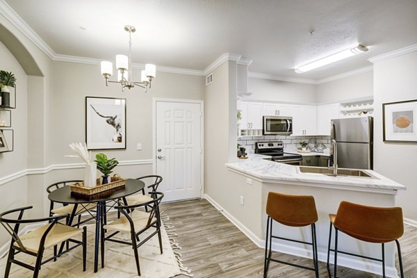 Elegant dining room with modern furnishings at Champions Apartments