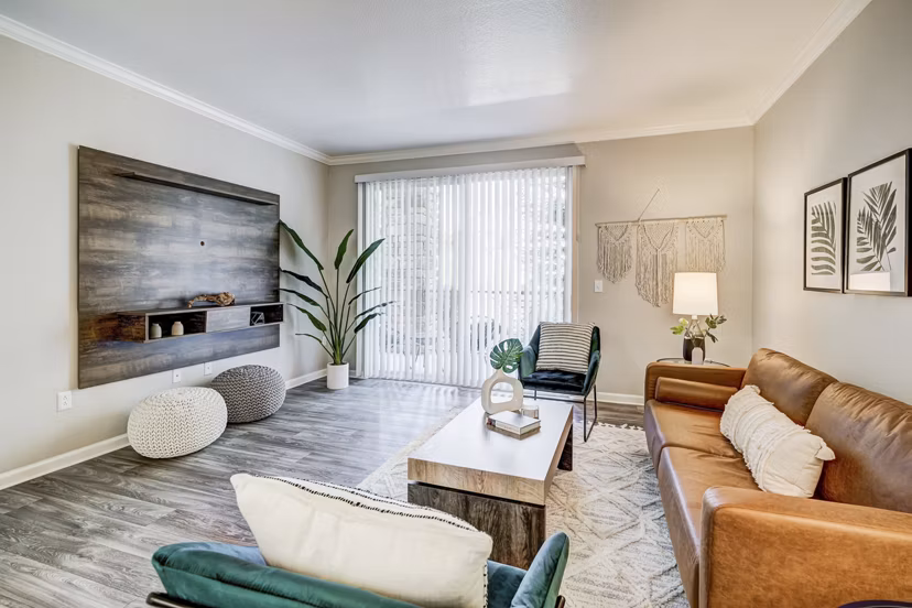Cozy living room with modern decor and a plush sofa in Champions Apartments