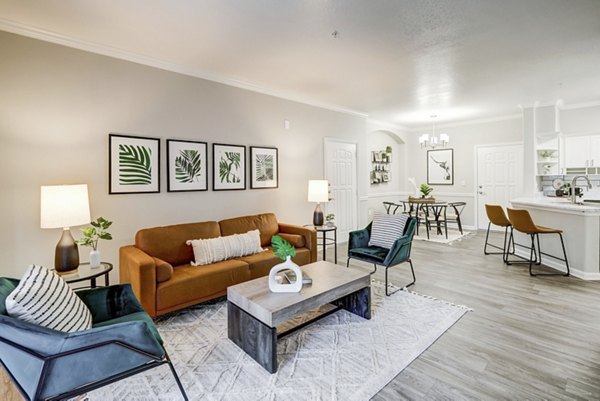 Living room with modern decor and natural light at Champions Apartments, a Greystar luxury property