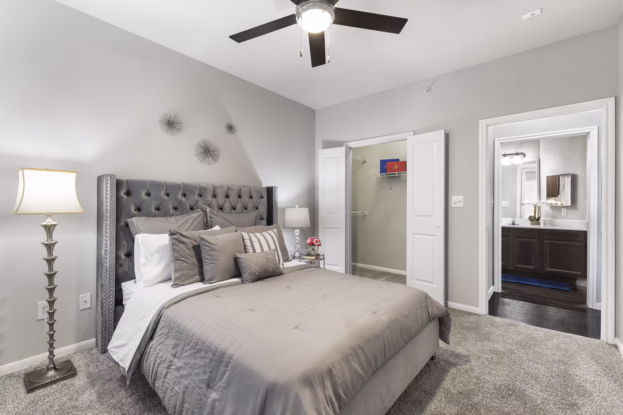 Cozy bedroom featuring modern decor and large windows in Villages at Turtle Rock Apartments