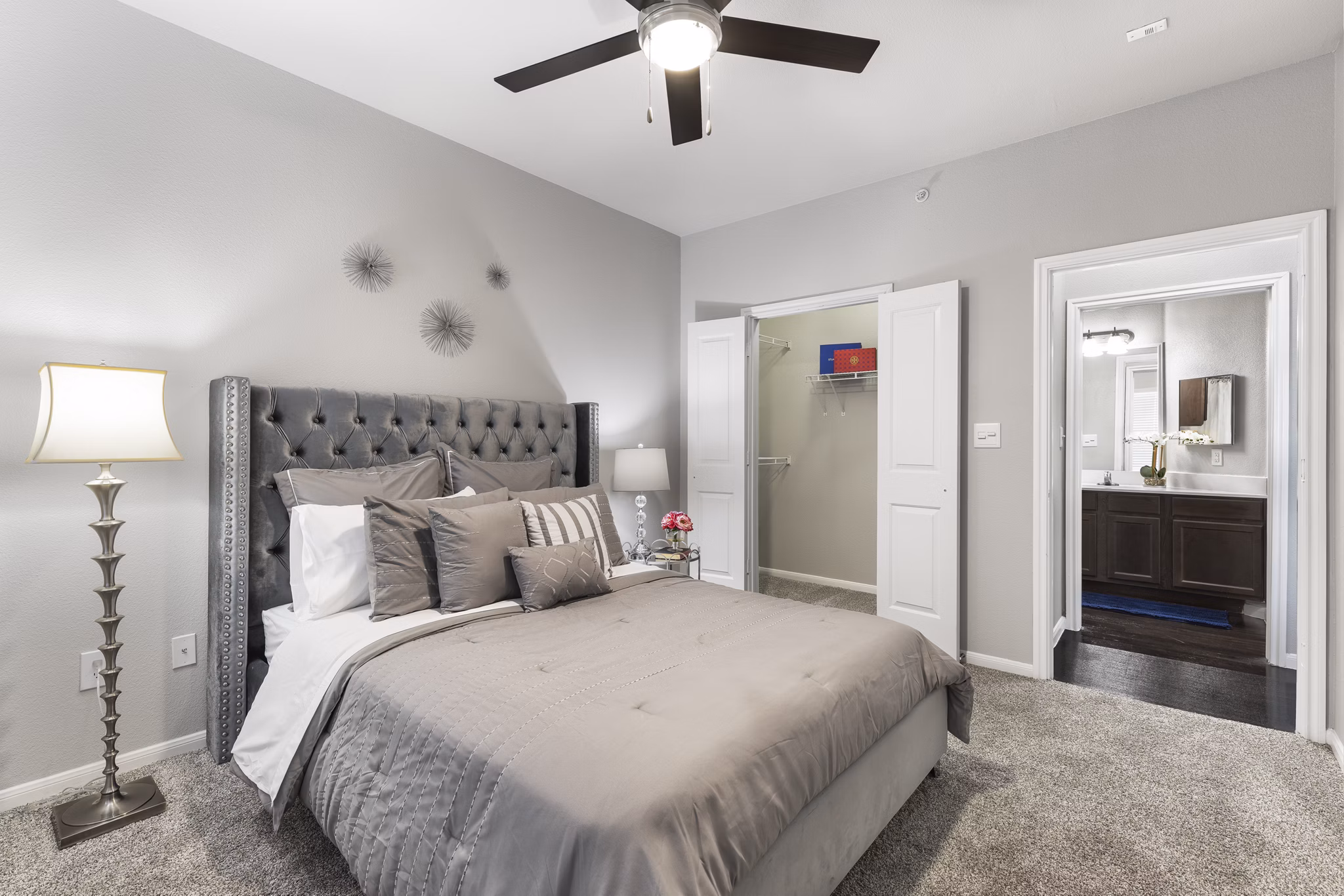 Cozy bedroom featuring modern decor and large windows in Villages at Turtle Rock Apartments