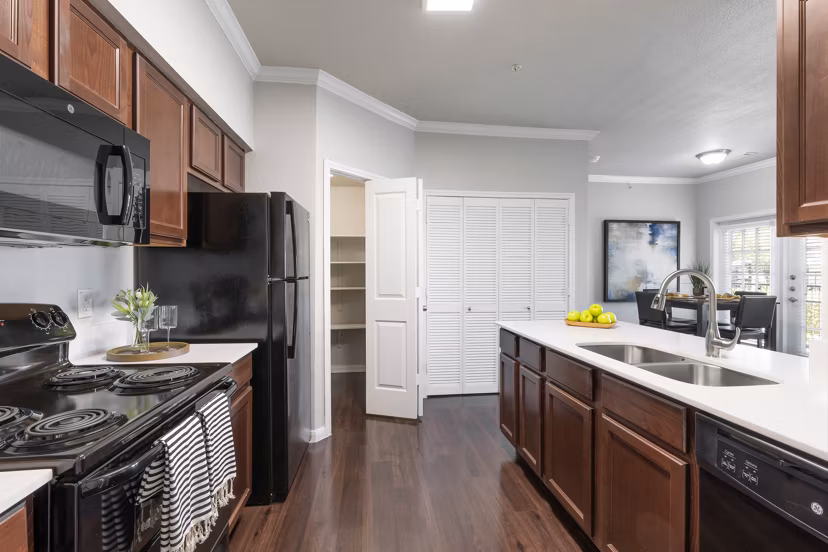 Modern kitchen with stainless steel appliances at Villages at Turtle Rock Apartments