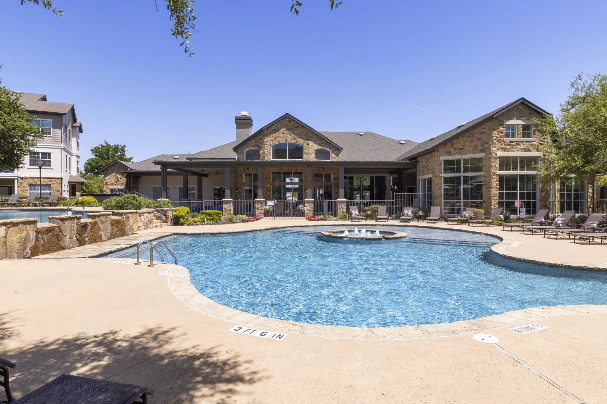 Sunny outdoor pool at Villages at Turtle Rock Apartments offering a luxury swimming experience