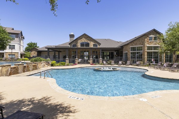Sunny outdoor pool at Villages at Turtle Rock Apartments offering a luxury swimming experience