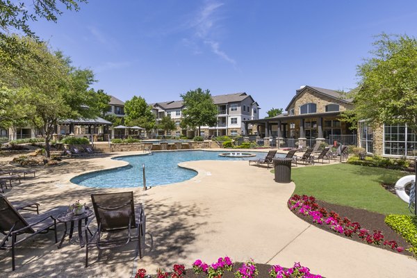 Stunning outdoor pool with lounge seating at Villages at Turtle Rock Apartments, perfect for relaxation and recreation