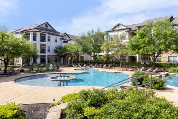 Resort-style outdoor pool with lounge seating at Villages at Turtle Rock Apartments