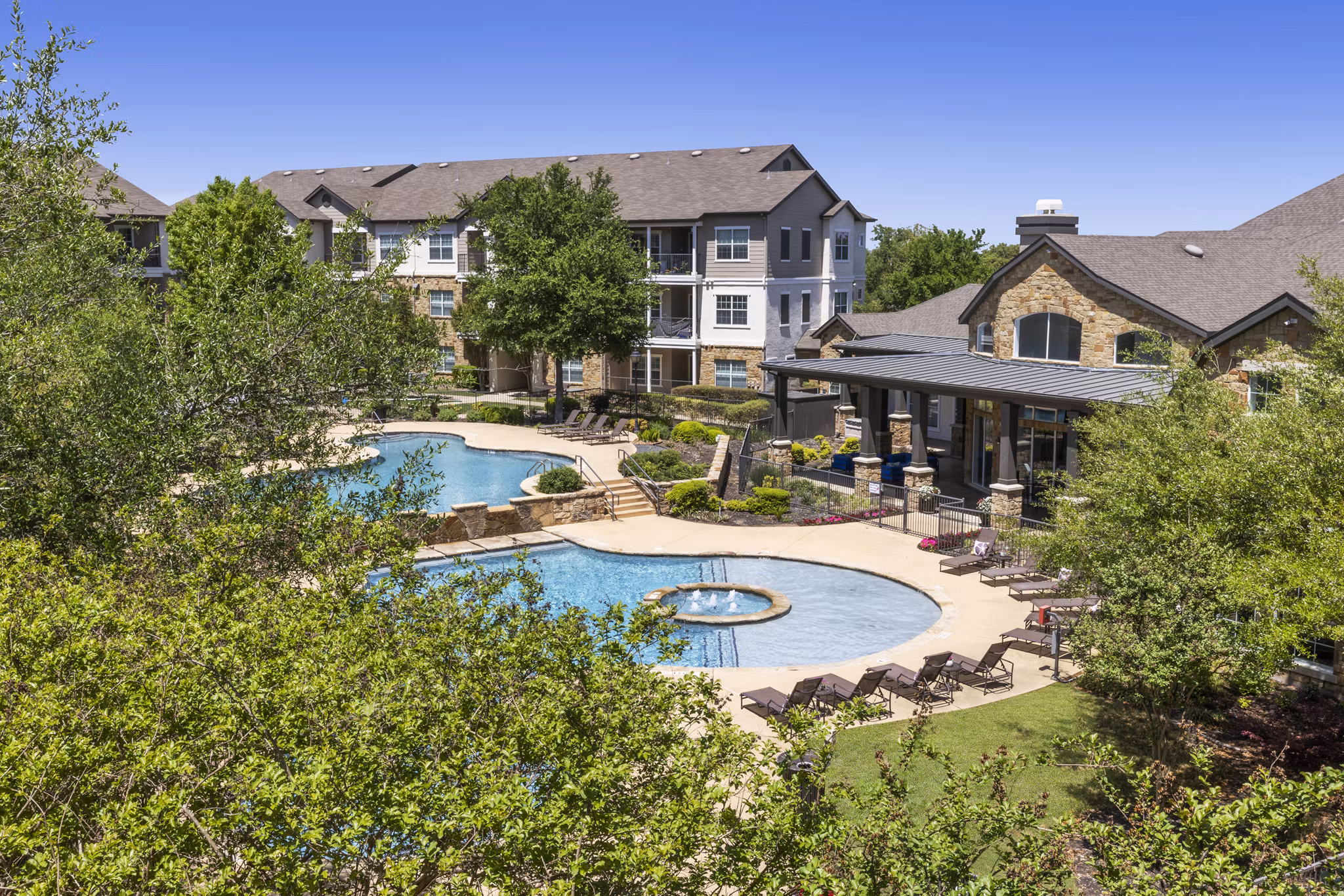 Villages at Turtle Rock: Scenic view of luxury apartments surrounded by lush greenery in a serene location