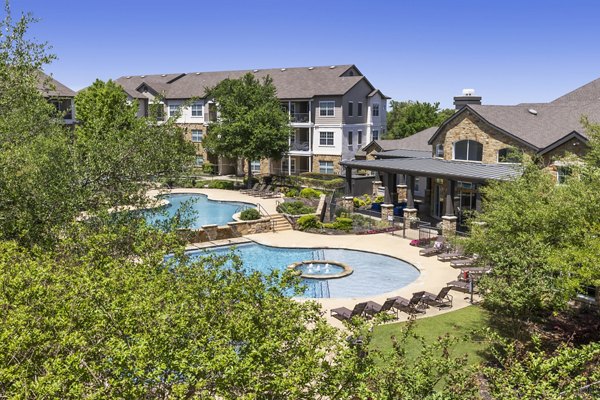 Villages at Turtle Rock: Scenic view of luxury apartments surrounded by lush greenery in a serene location