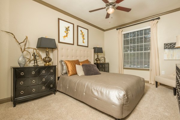 Cozy bedroom with elegant decor at Deerwood Apartments, offering luxury living