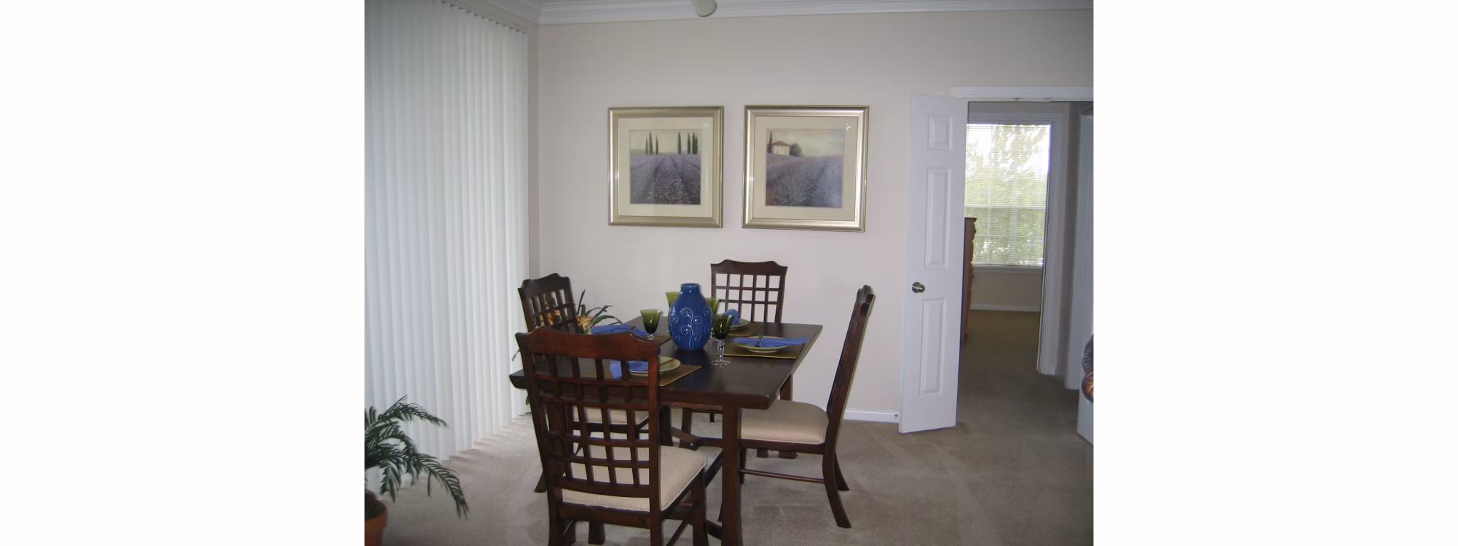 Dining room with elegant chandelier and modern furnishings at Reserve at Fountain Lake Apartments