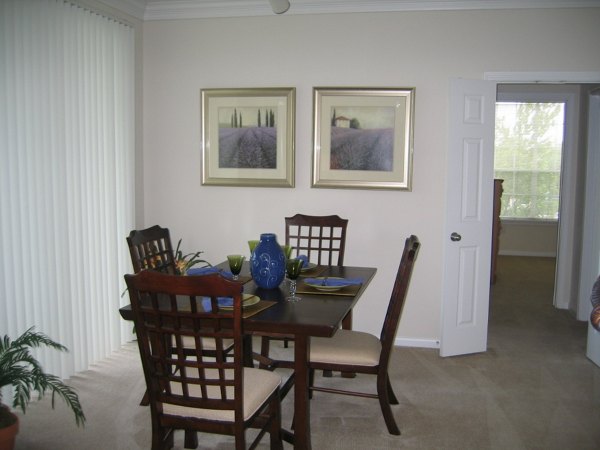 Dining room with elegant chandelier and modern furnishings at Reserve at Fountain Lake Apartments