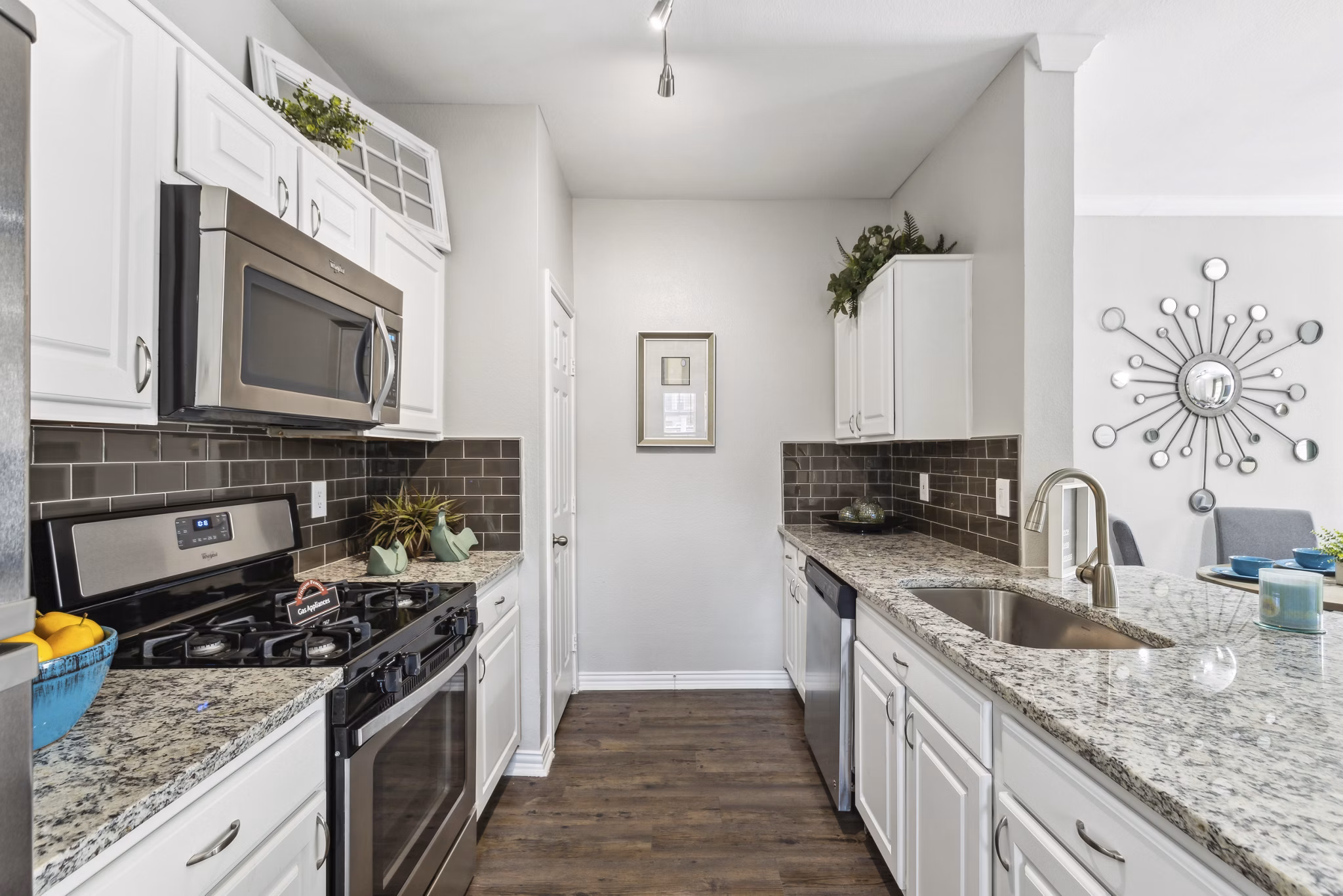 Kitchen featuring modern appliances and sleek countertops in Towns of Chapel Hill Apartments