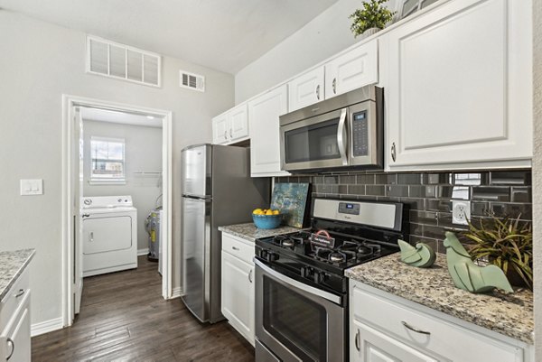 Modern kitchen with stainless steel appliances at Towns of Chapel Hill Apartments