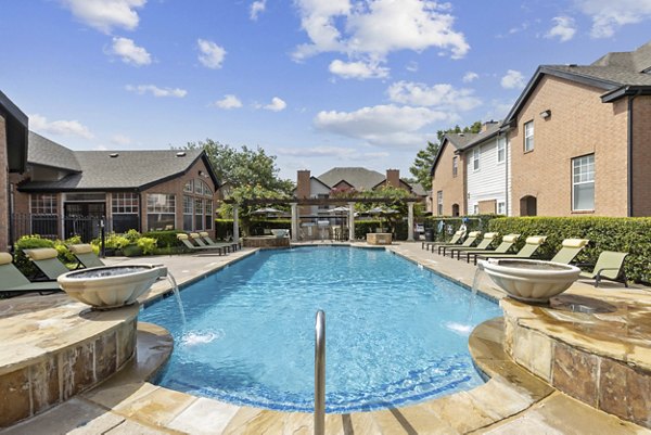 Refreshing pool with sun loungers at Towns of Chapel Hill Apartments, ideal for relaxing on sunny days