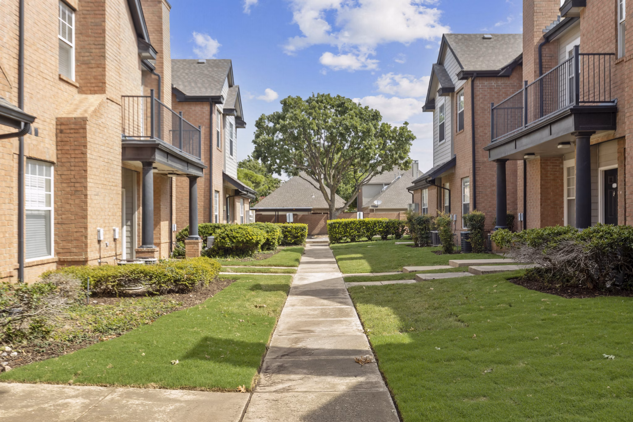 Recreational area with modern design at Towns of Chapel Hill Apartments, featuring outdoor seating and greenery