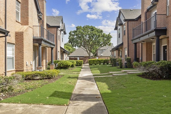 Recreational area with modern design at Towns of Chapel Hill Apartments, featuring outdoor seating and greenery