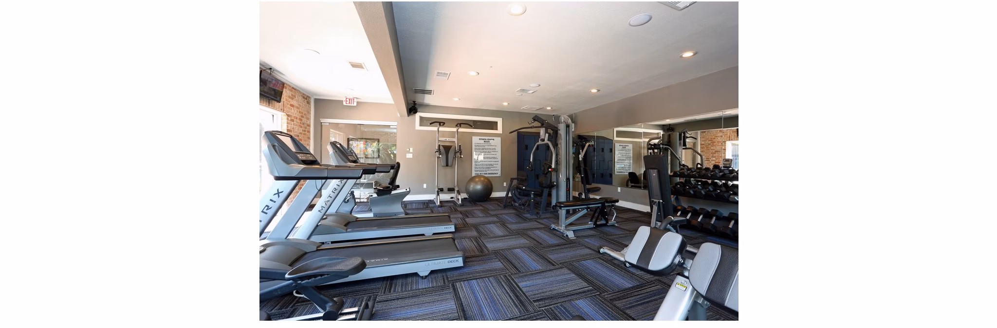 fitness center at The Village at Gracy Farms Apartments