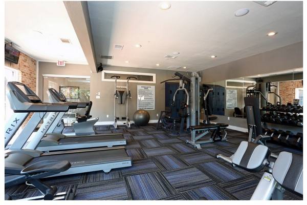 fitness center at The Village at Gracy Farms Apartments