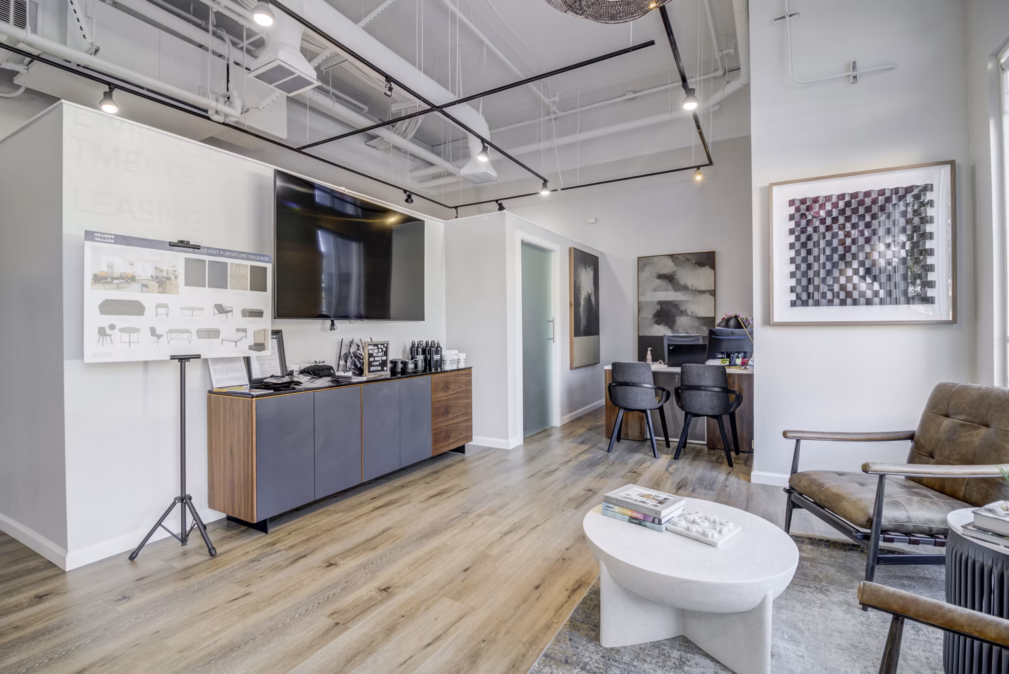 Modern clubhouse with cozy seating and fireplace at Hillside Village Apartments