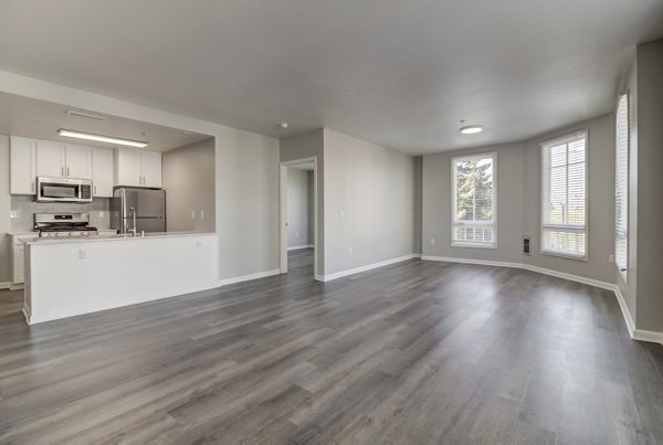 Spacious living room with modern decor in Hillside Village Apartments, featuring cozy seating and elegant lighting for luxury living