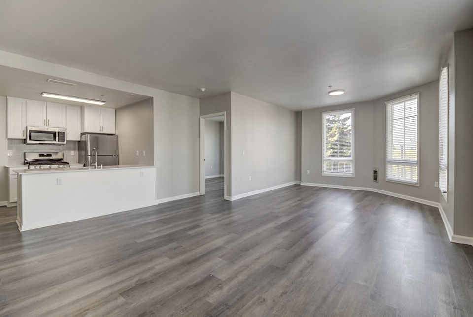 Spacious living room with modern decor in Hillside Village Apartments, featuring cozy seating and elegant lighting for luxury living