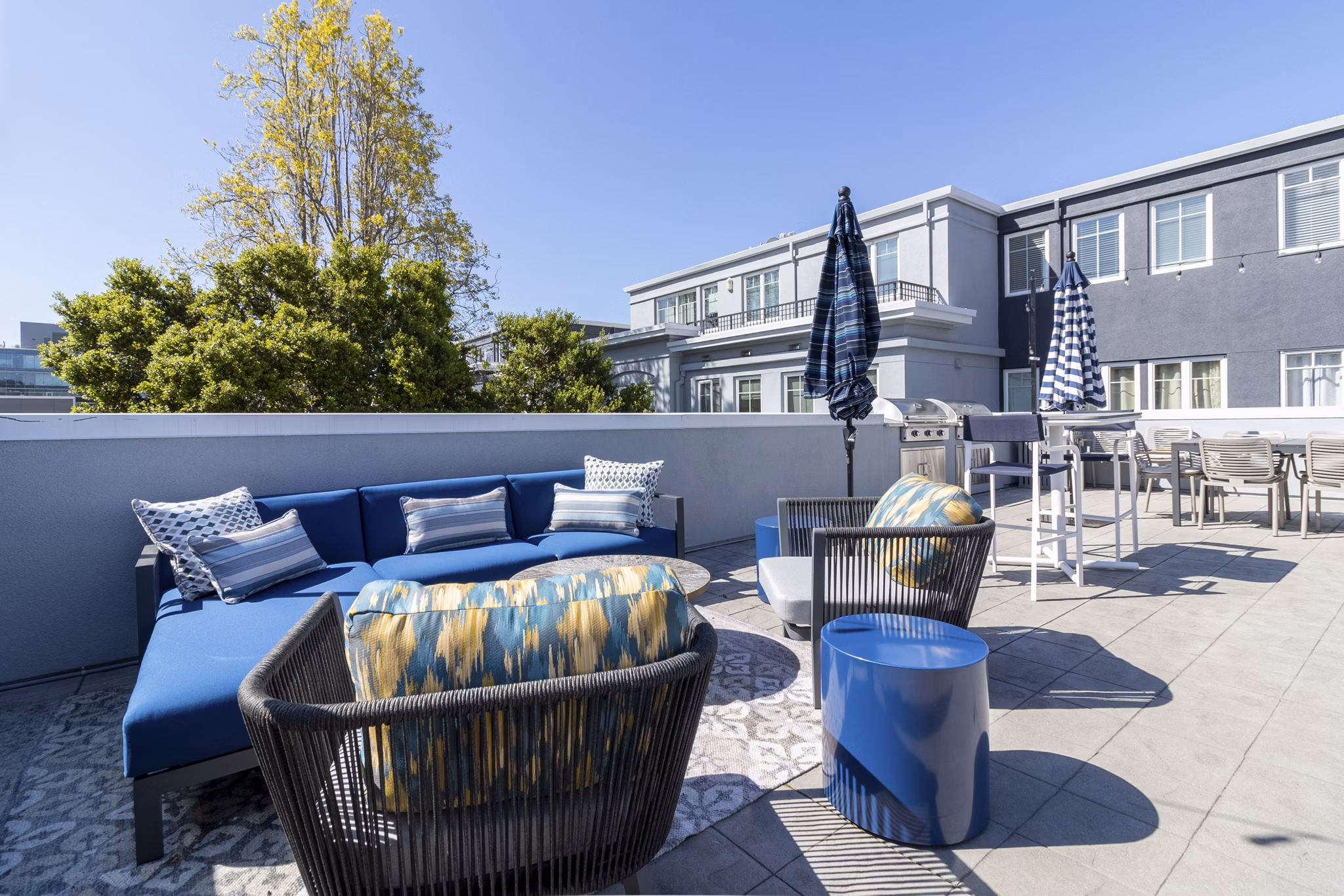 Rooftop deck with outdoor seating at Hillside Village Apartments offering stunning views