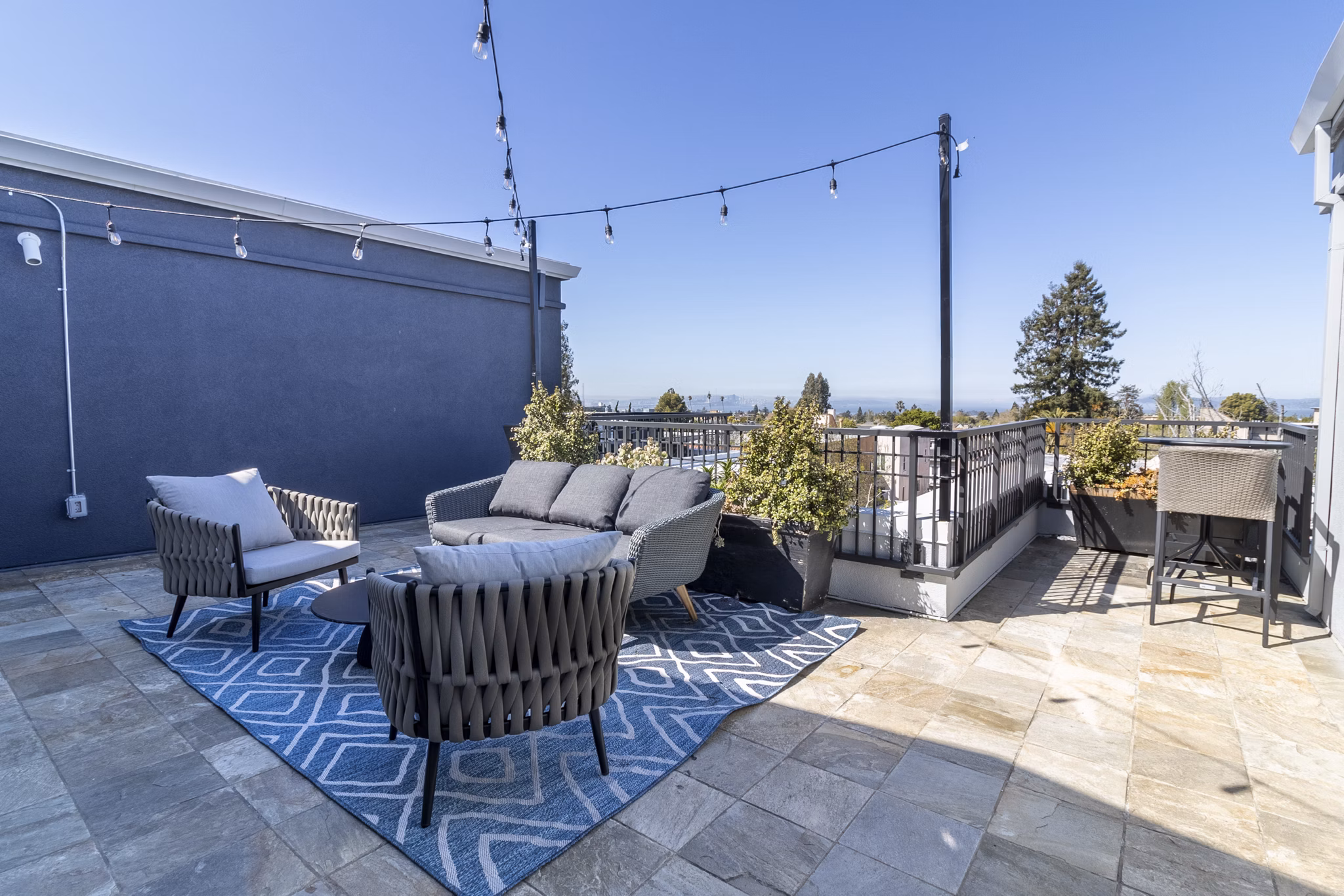 Rooftop deck with city skyline views at Hillside Village Apartments