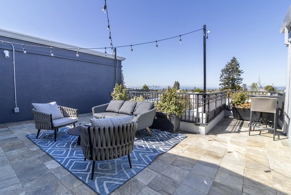 Rooftop deck with city skyline views at Hillside Village Apartments
