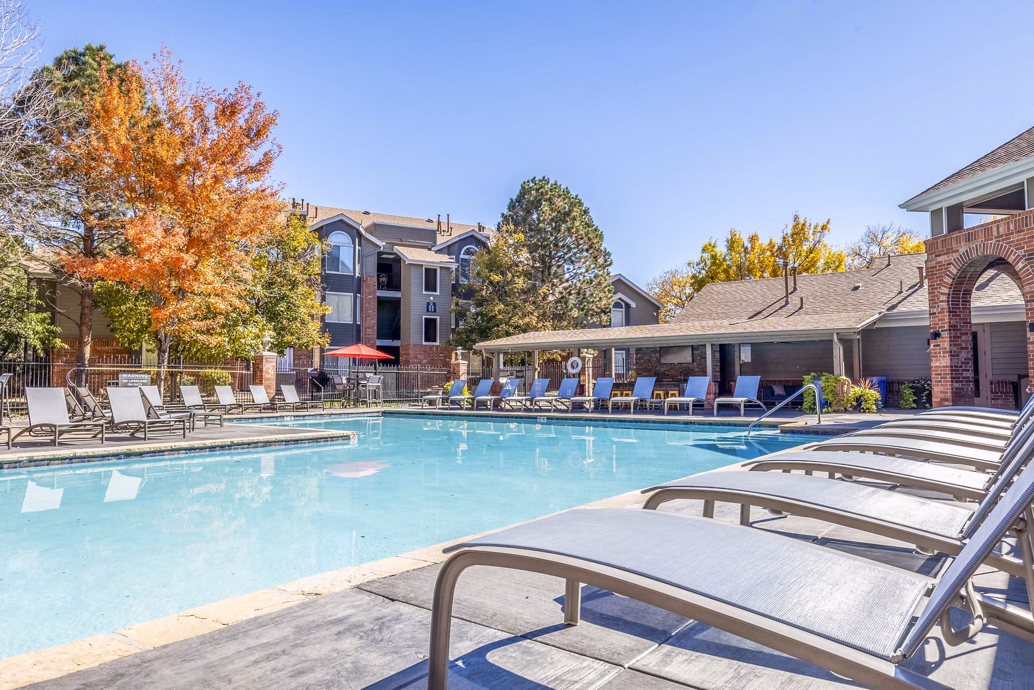 Pool with elegant landscaping at Waterford Cherry Creek Apartments, offering luxury amenities and serene outdoor spaces