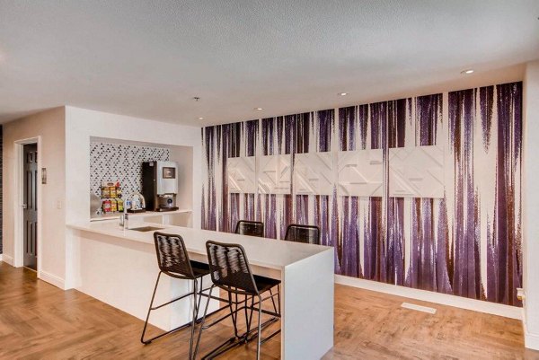 Modern clubhouse with cozy seating and pool table at The View on 26th Apartments
